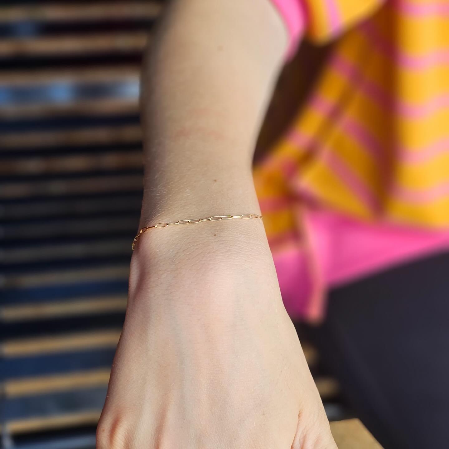 Dainty 14k gold-filled paperclip permanent bracelet welded on a wrist — Forever Linked Permanent Jewelry, Athens GA